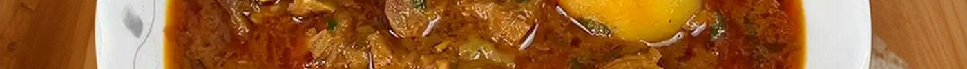 Bowl of rich meat curry on a wooden table