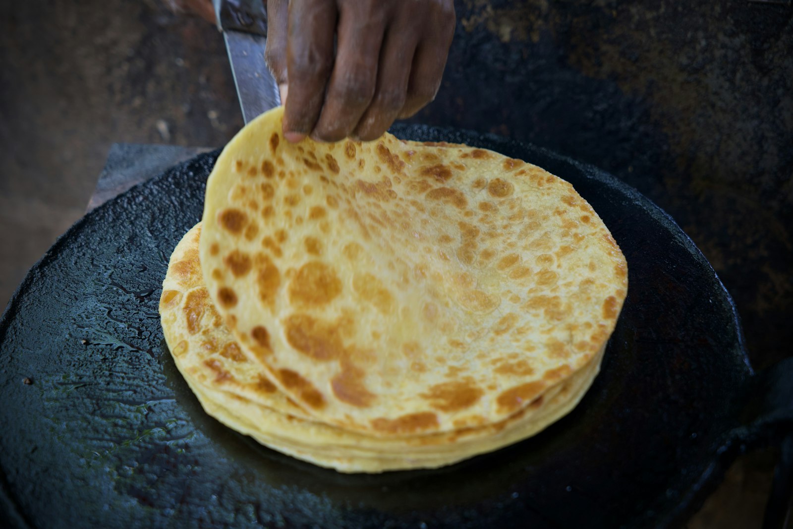 Flatbread cooking on a hot, flat griddle (tawa)