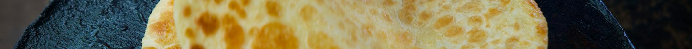 Flatbread cooking on a hot, flat griddle (tawa)