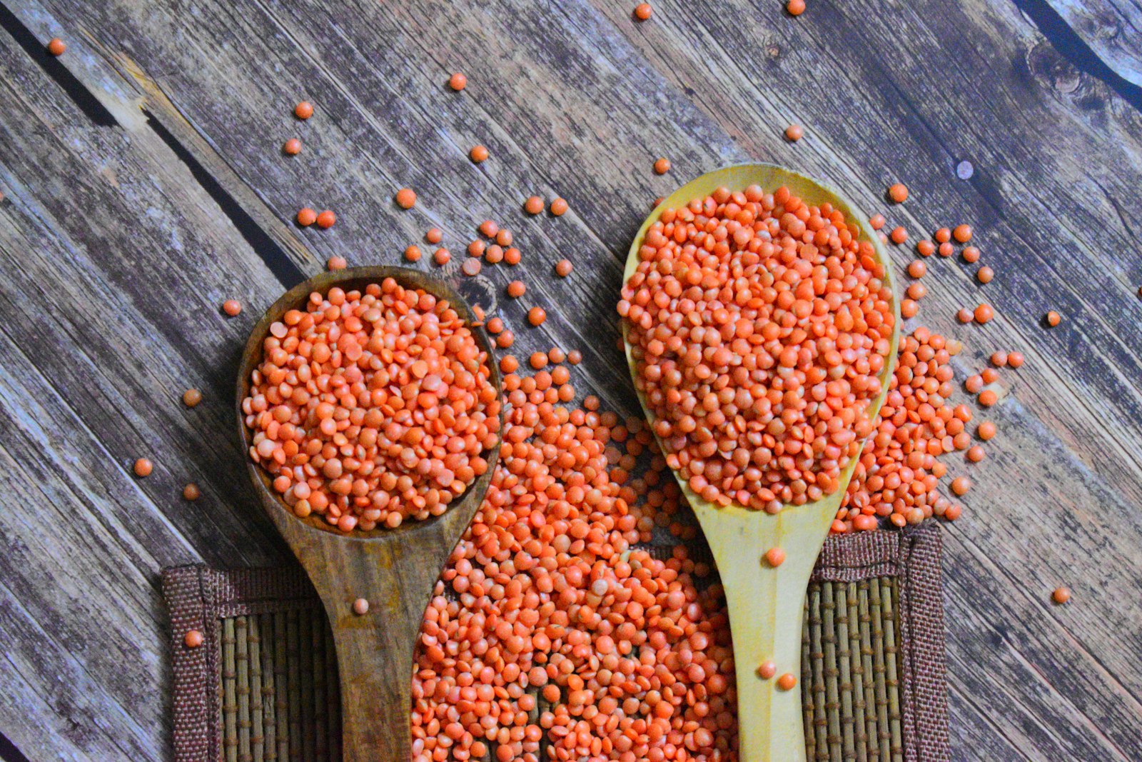 Two wooden spoons of red lentils (masoor dhal)