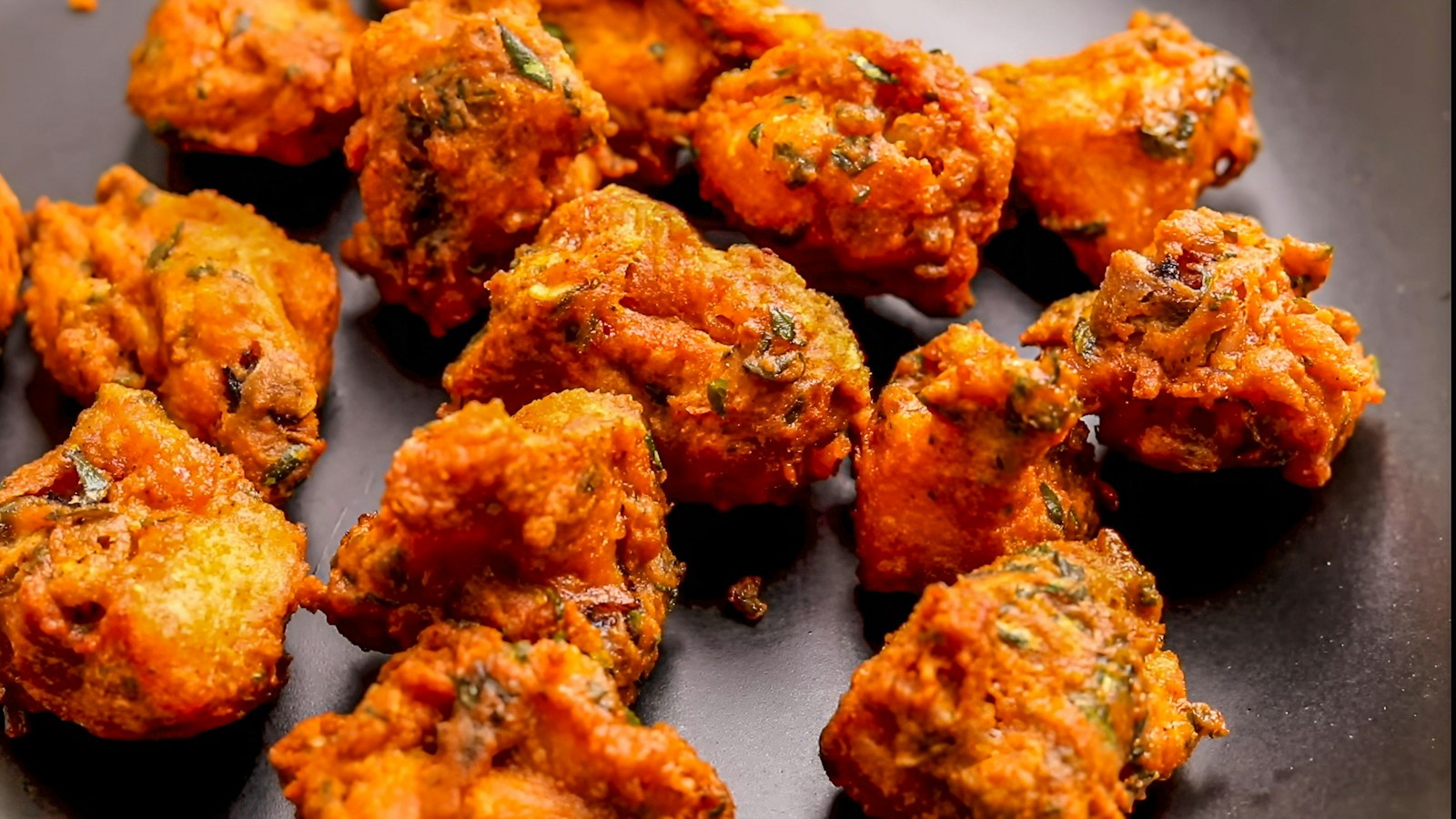 Plate of golden brown fried fritters (bhajia)
