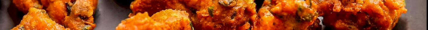 Plate of golden brown fried fritters (bhajia)